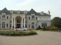 Two story mansion with gravel driveway