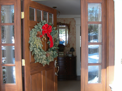 Open Front Door with a Hanging Christmas Wreath