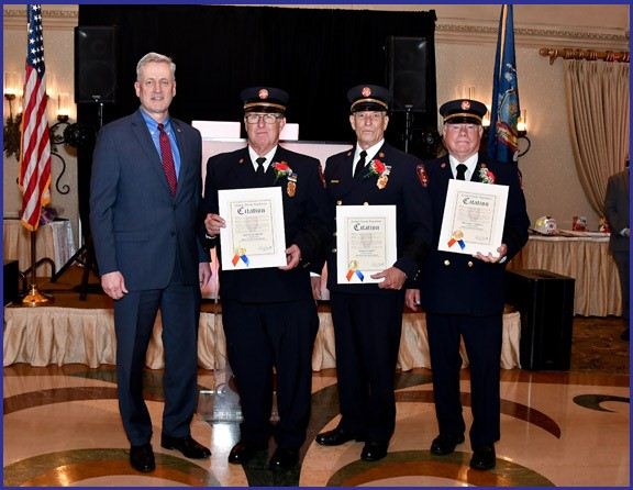 Officer Nicolello Salutes Mineola Fire Department 50 Year Members