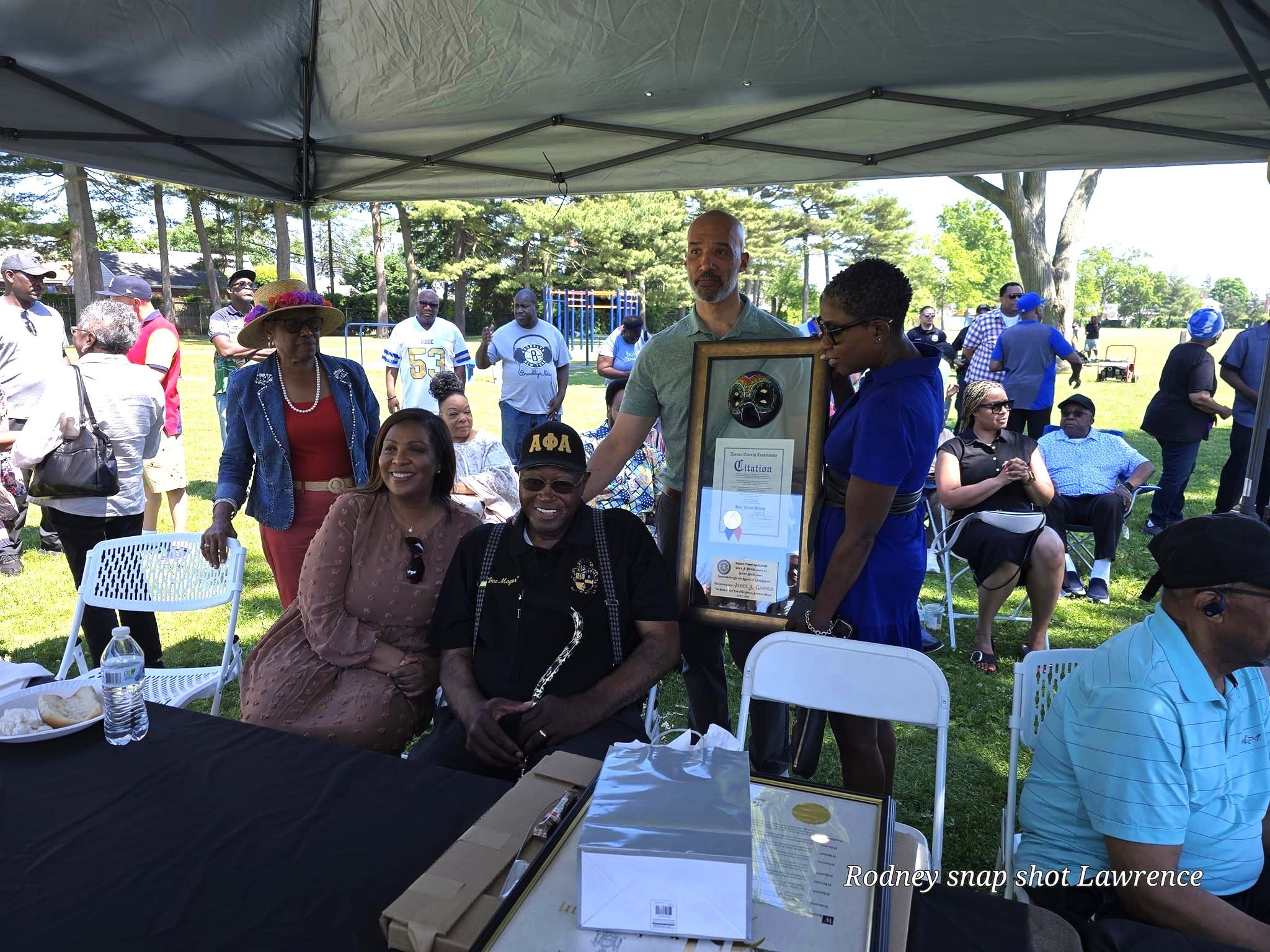 Legislators Bynoe and Davis present a Nassau County Legislature Citation to James Garner, seated next to New York State Attorney General Letitia James, in recognition of his historic achievements and leadership in the Village of Hempstead.