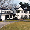 Exterior of large white home with colonnade