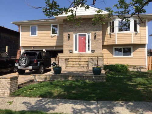 Front of home with two cars in driveway